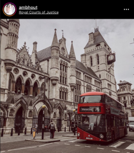 Red bus in front of royal courts of justice, taken from instagram.