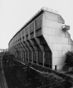 Exterior view of Alexandra Road flats backing onto a train track.