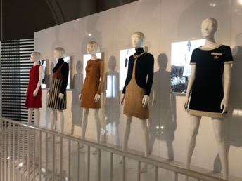 Five mannequins in museum wearing mini skirt dresses