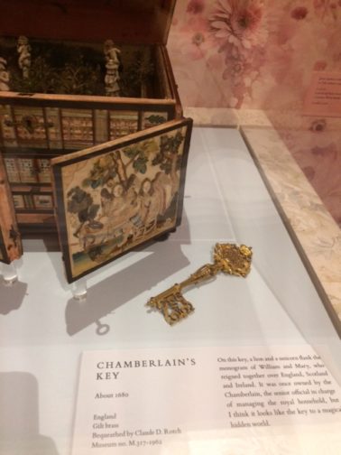 Gold, decorative key in museum vitrine.