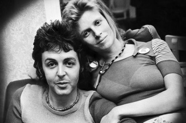 Photograph of Paul and Linda McCartney in black and white leaning into each other and looking at the camera.