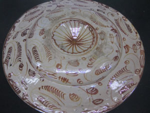 Reverse of the dish, showing a warm hue