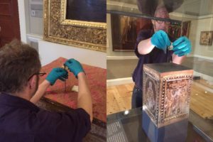 man installing miniature bible on a plynth in the Courtauld's gallery
