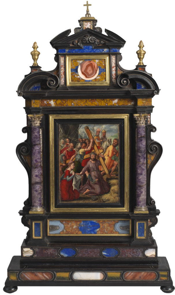 decorated frame with precious stones on the side and a painted biblical scene in the middle