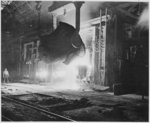 A 1940s black and white photograph of a vat of molten pig iron at an ironworks