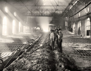 Illinois metalworkers casting pig iron ingots around 1900