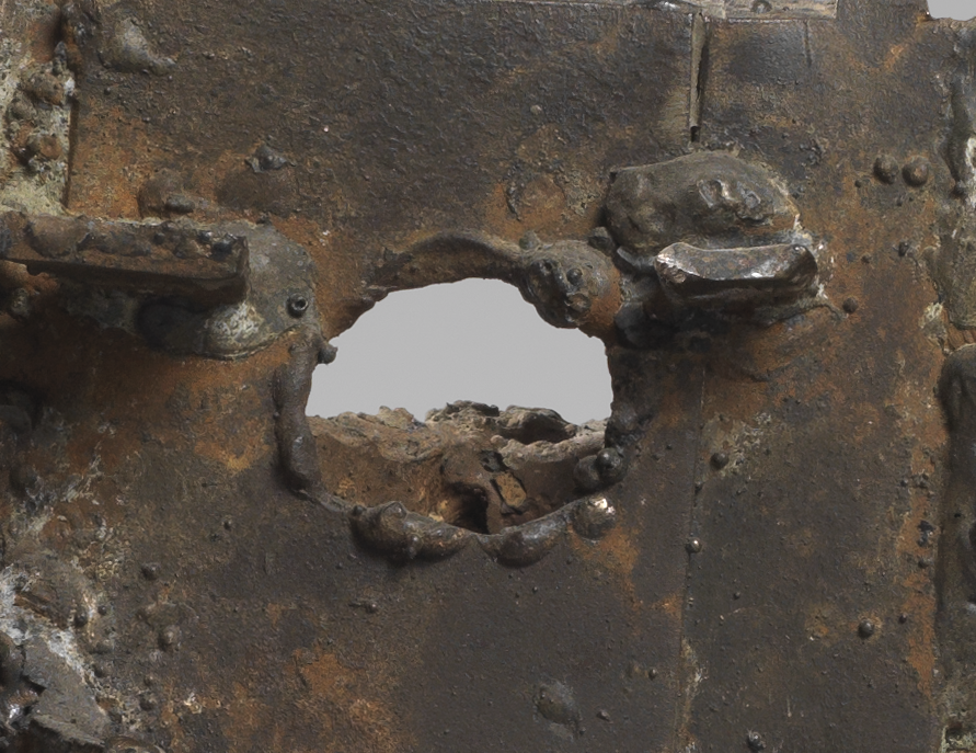 Close up of César's Habitaion sculpture showing a hole in a steel sheet made with a gas flame