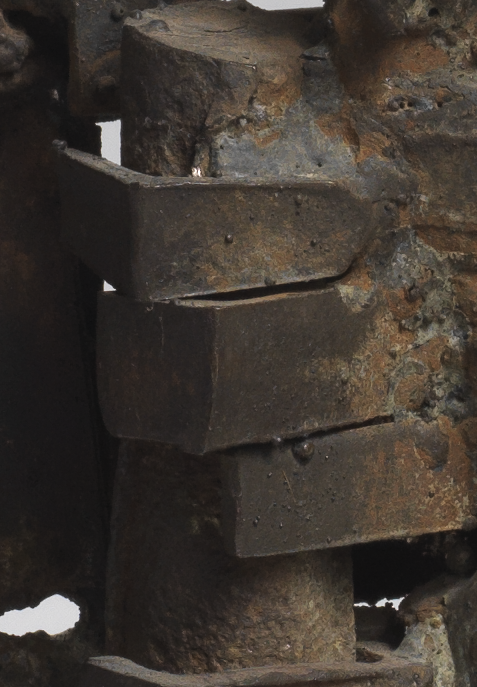 A close up of César's Habitation sculpture, showing an metal bar, possibly of wrought iron