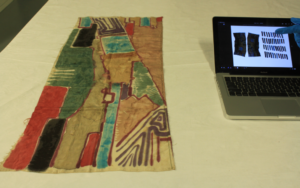 full length of scarf, with laptop showing photo