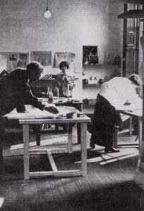 Three artists working in a studio