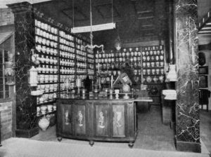 In a mock-up of Italian pharmacy in 16th century, there are dozens of pharmacy jars are aligned on shelves behind the counter.