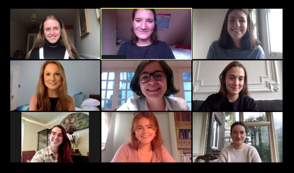 The nine curators in a zoom meeting, smiling at the camera.