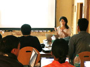 Amarilli Rava giving a lecture in front of a class with four students