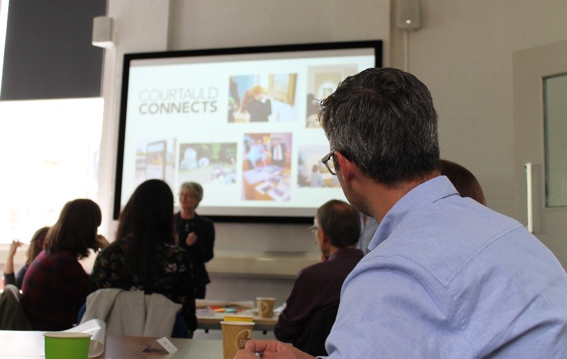 a person delivering a powerpoint presentation for the partners networking day