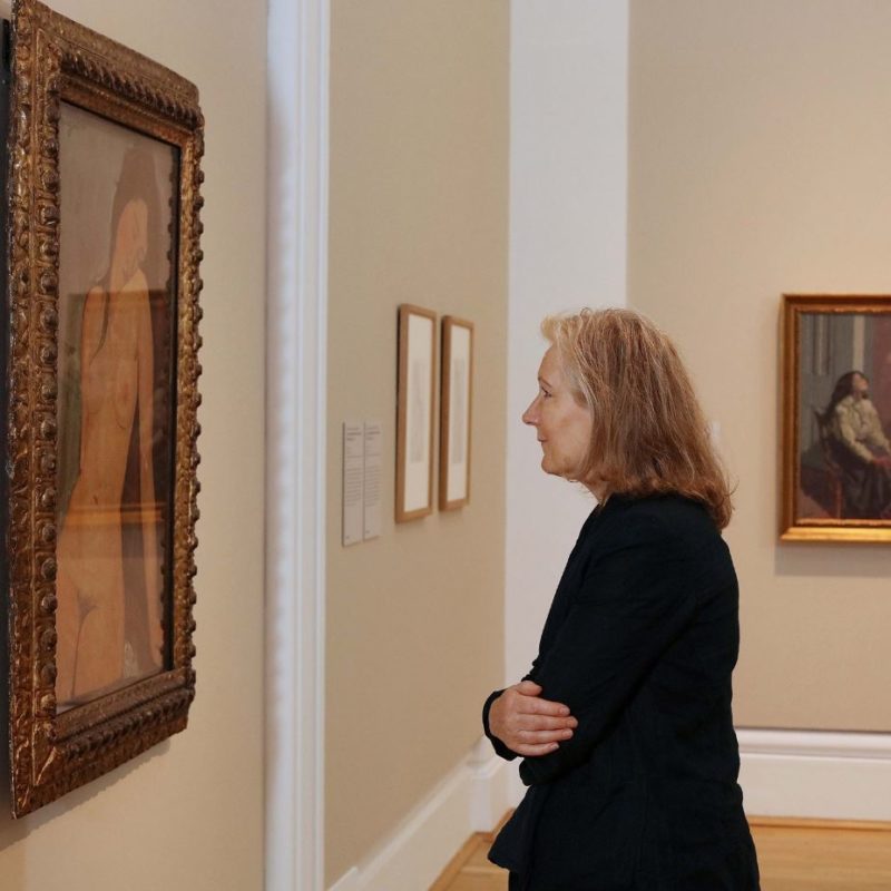 a person standing in front of a Modigliani painting in Ulster's museum