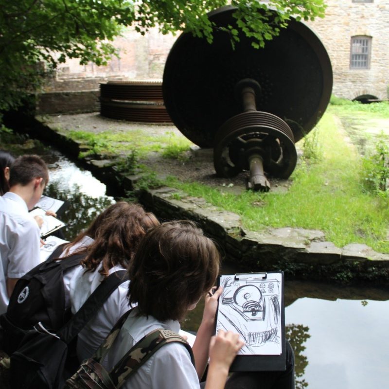 young students drawing outdoors