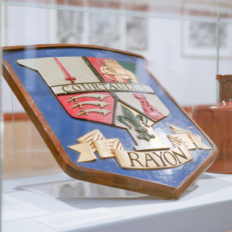 The Courtaulds crest in a display cabinet