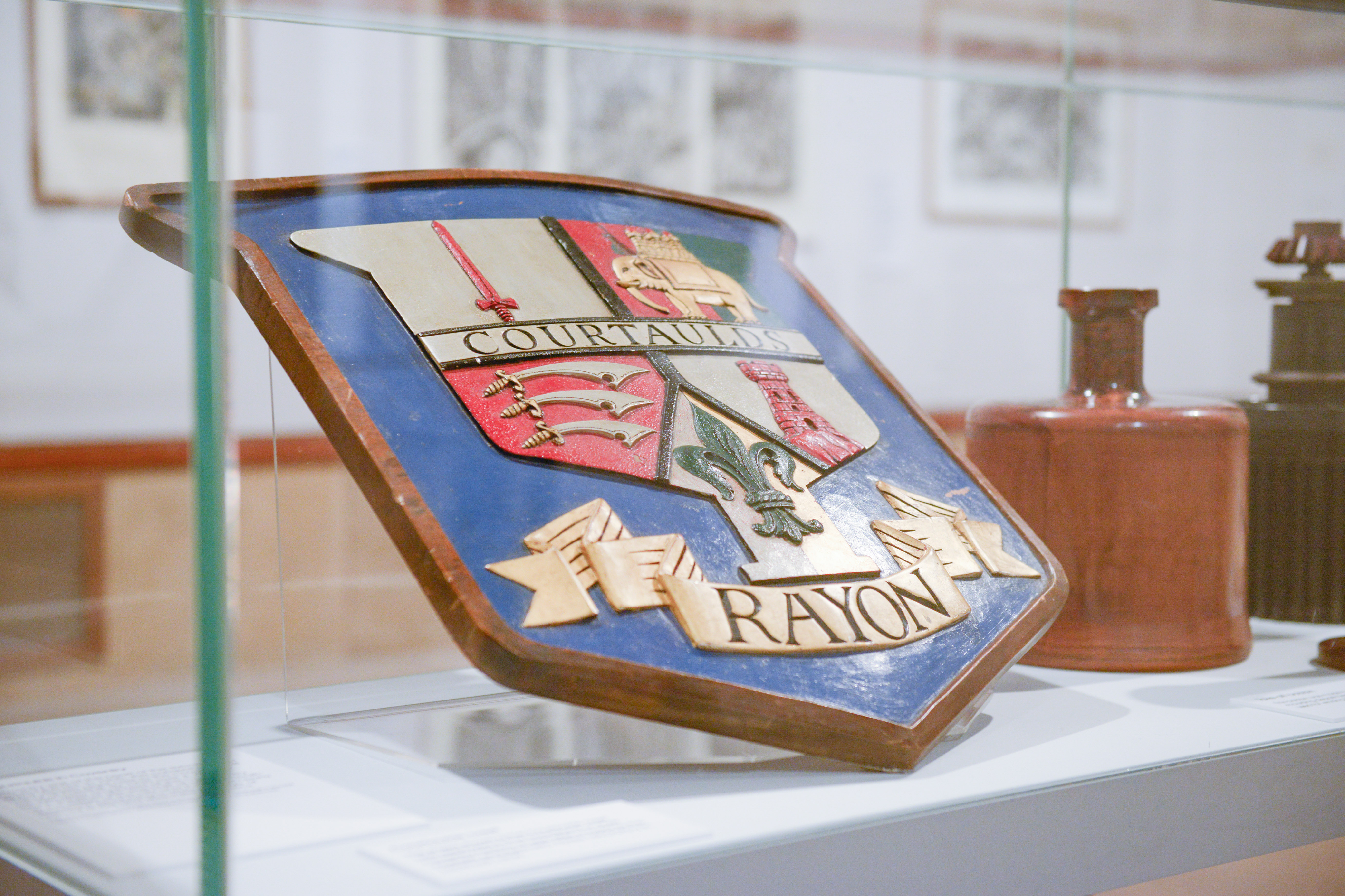 The Courtaulds crest in a display cabinet