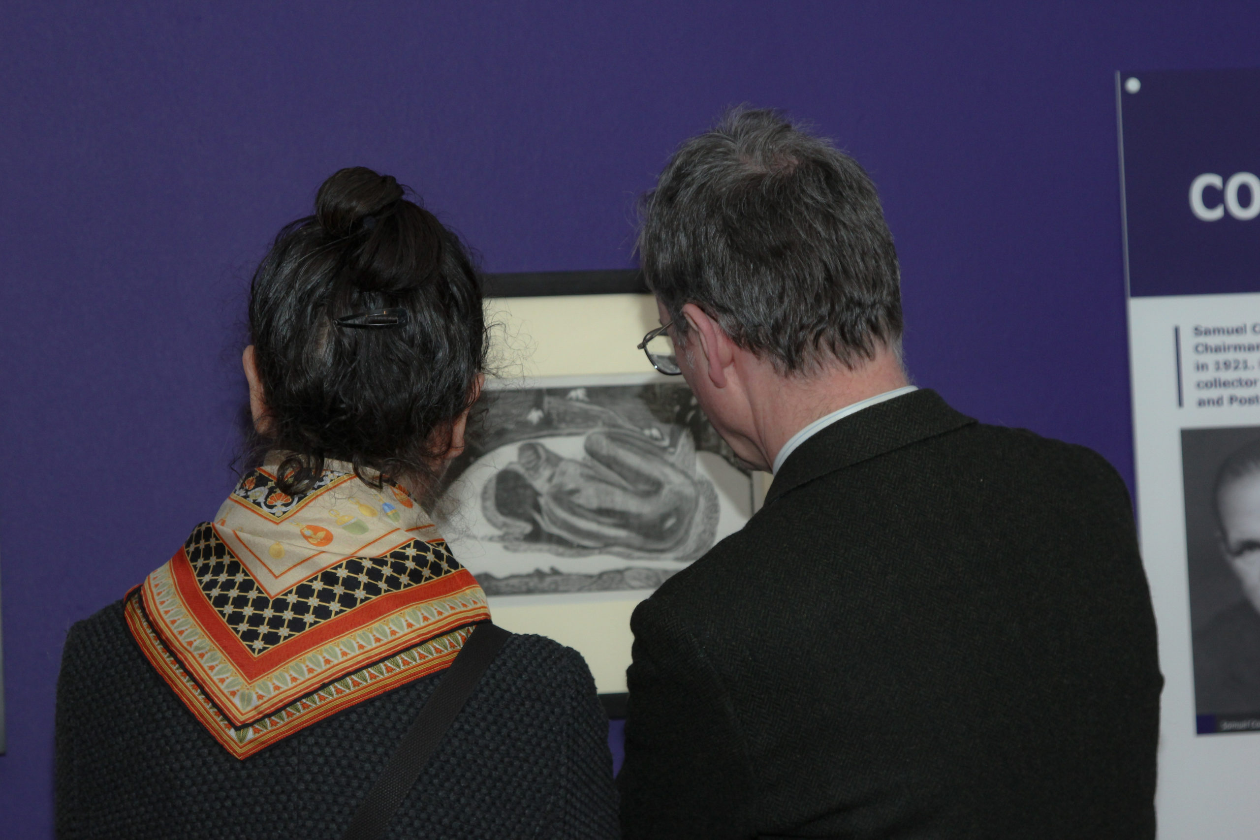Visitors view Gauguin print at Braintree Museum