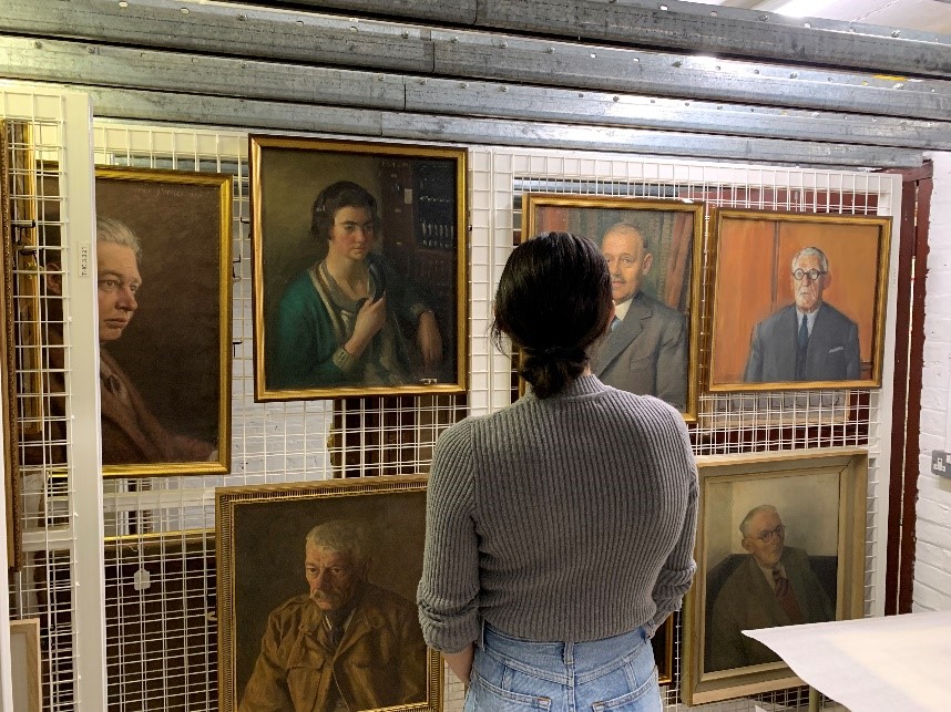 Cat Dussault viewing the Old Iron Portrait collection in the Art Store.