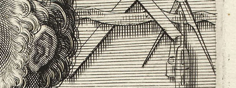 detail of engraving with compass and ruler in the background